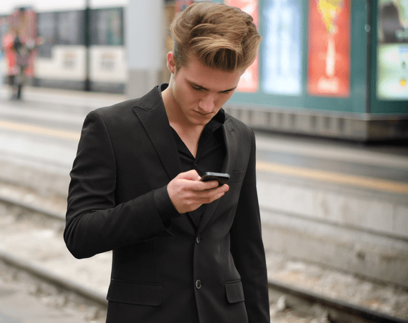 A man looking at his phone. He might be using sexting AI chatbot - artificial intelligence sex chat