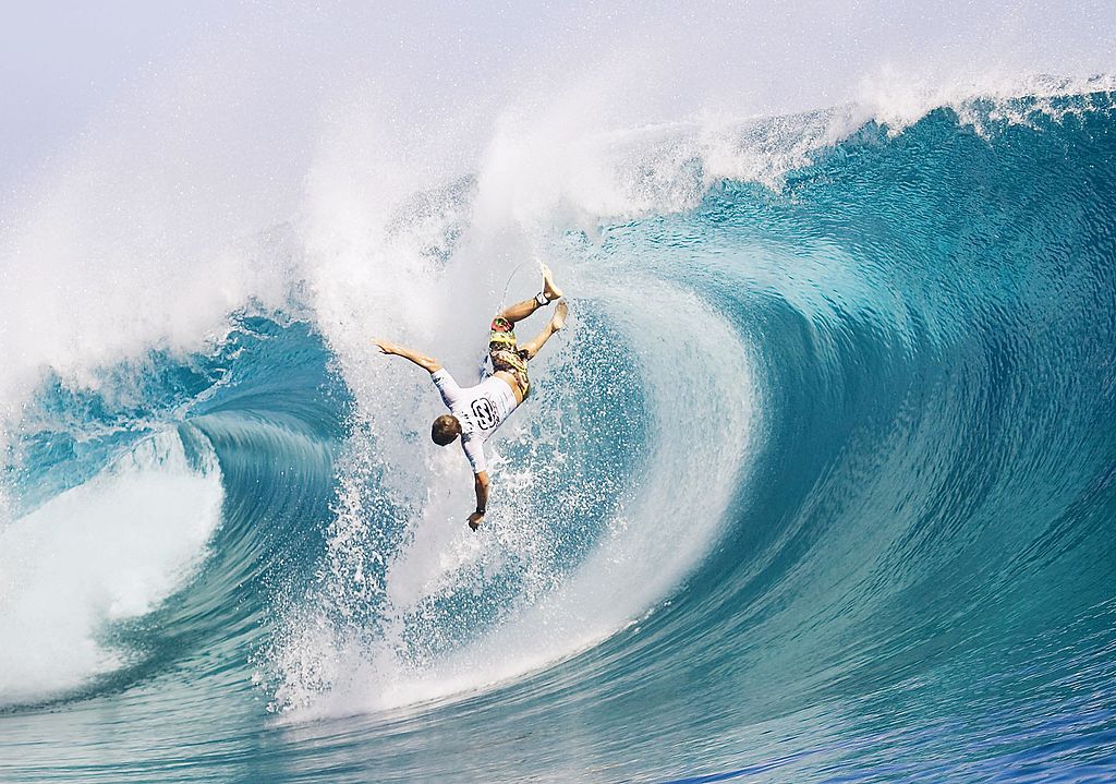 A surfers wipes on on bitcoin beach. He is there to spend his crypto or cryptocurrency, and could be headed for bitcoin jungle.