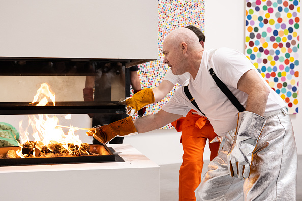 Damien Hirst burning thousands of pieces of his art in a furnace. 