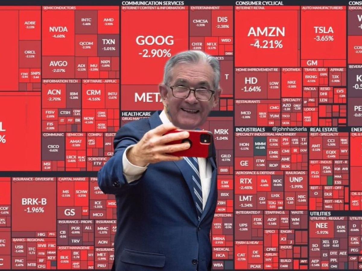 Jerome Powell taking selfie in front of red stocks meme