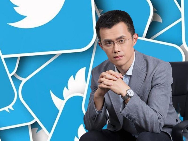 Binance CEO Changpeng Zhao sitting in front of a wall of blue Twitter logos