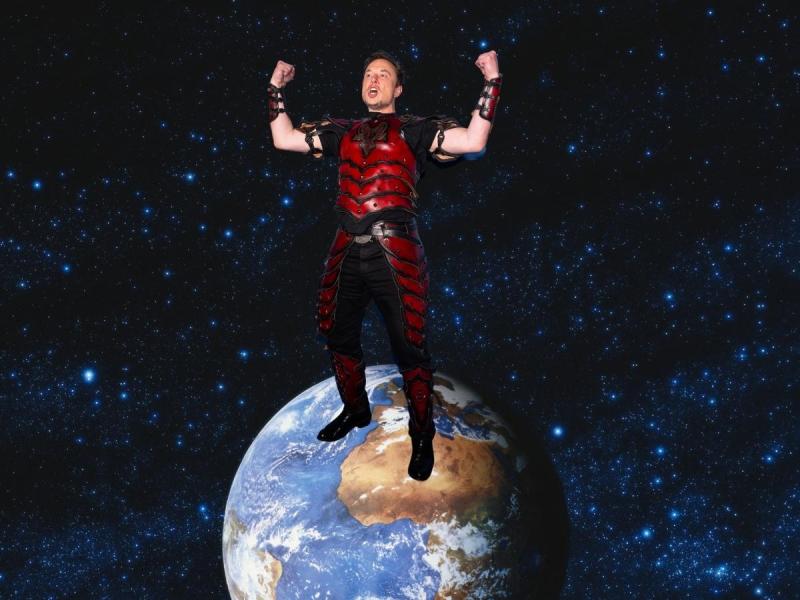 Elon Musk in his halloween outfit standing on top of the world
