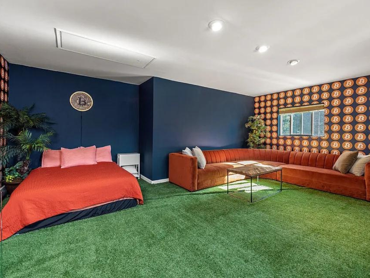 The crypto house's Bitcoin-themed master bedroom, complete with astro turf carpet. Perfect for a good nights sleep.